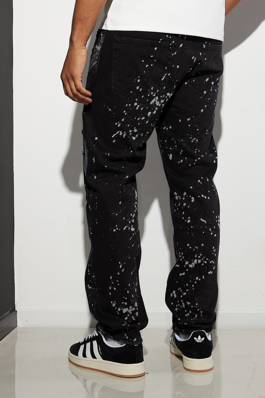 Black ripped jeans with paint splatter