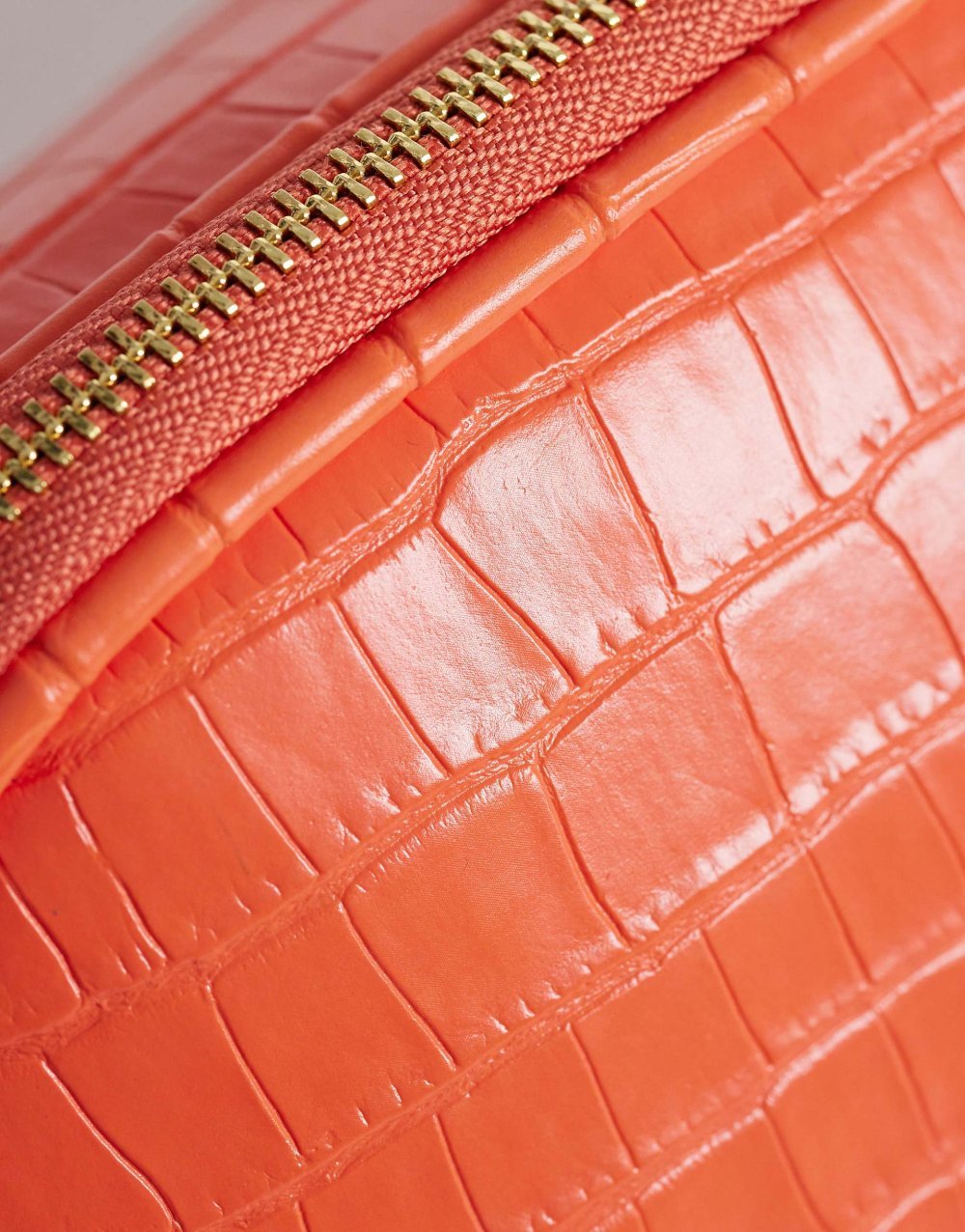 Orange croc effect clutch bag