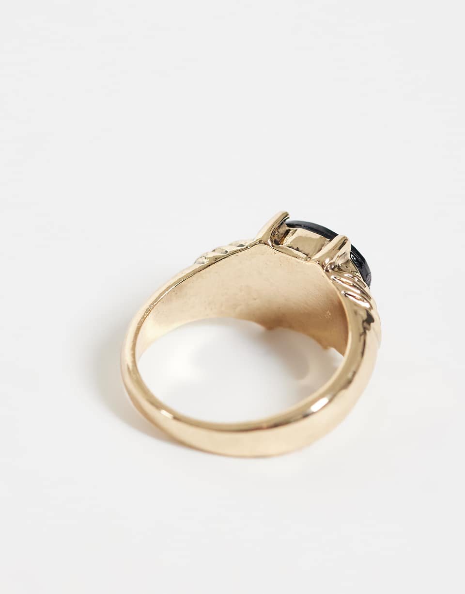 Gold tone ring with black set stone