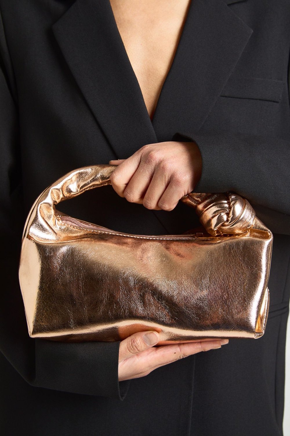 Rose gold metallic grab bag with knot handle