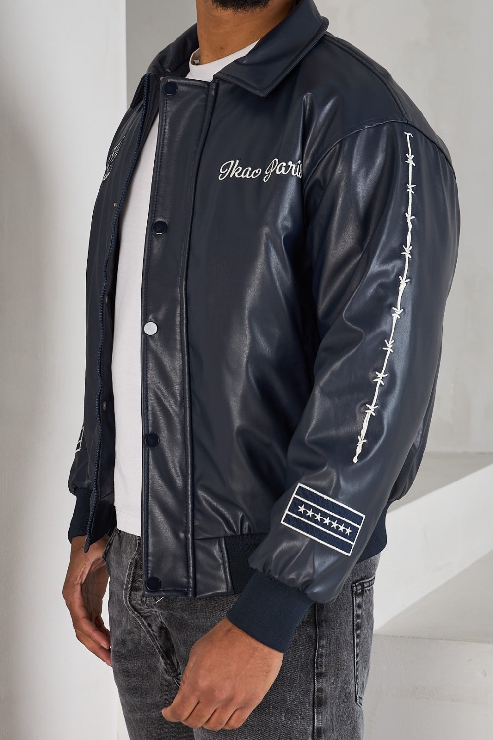 Black bomber jacket with white lettering