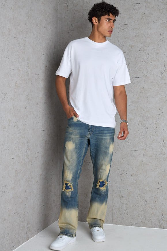 Dark blue flared jeans with washed stain effect