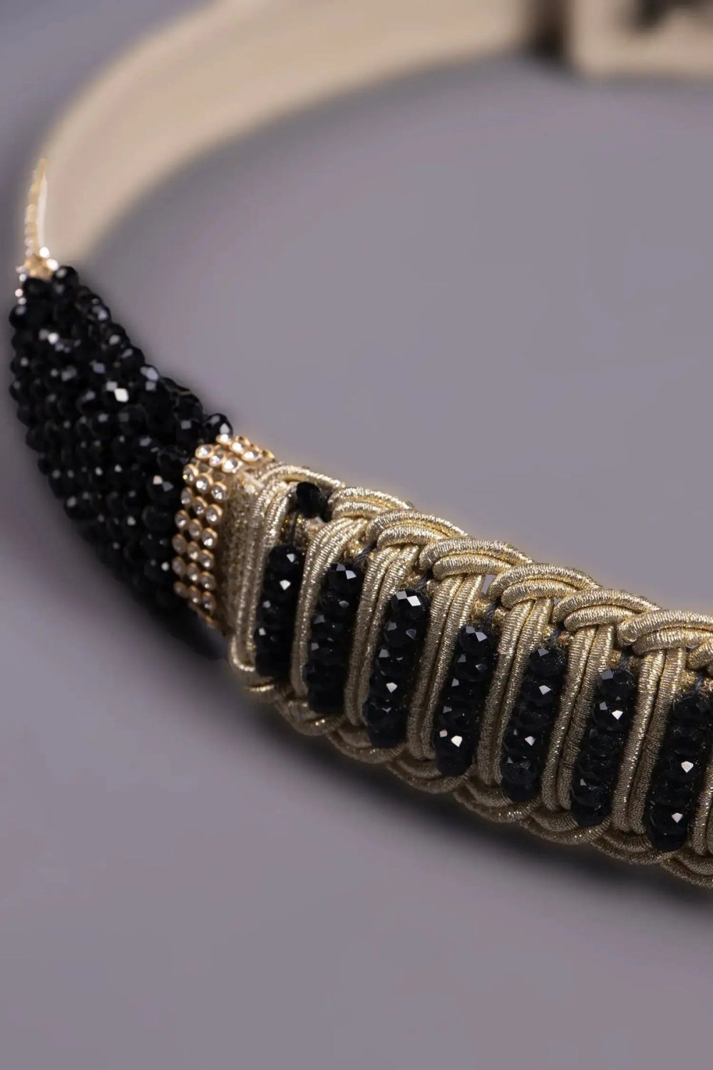 Gold belt with dense black bead braiding