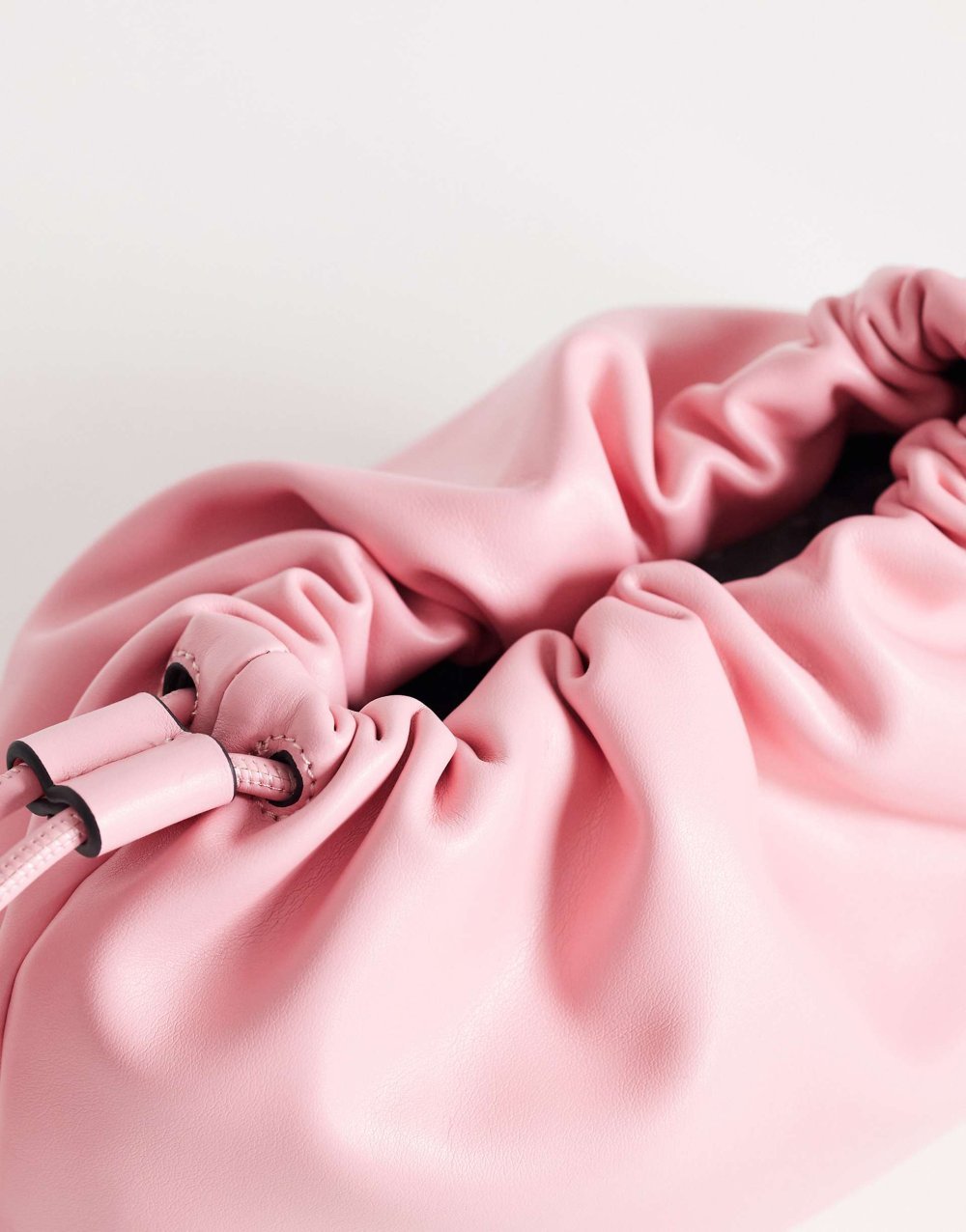 Pink ruched faux leather clutch bag