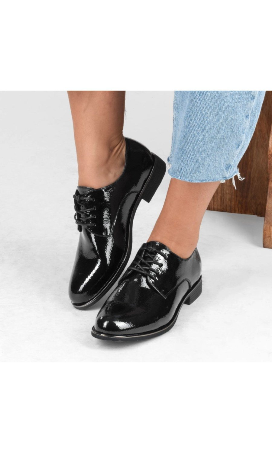Black patent derbies with metallic trim