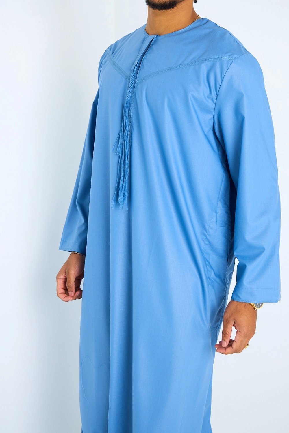 Long blue high-neck qamis with tassels