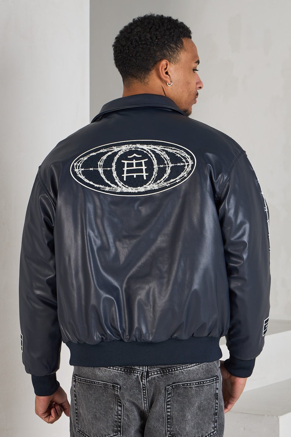 Black bomber jacket with white lettering