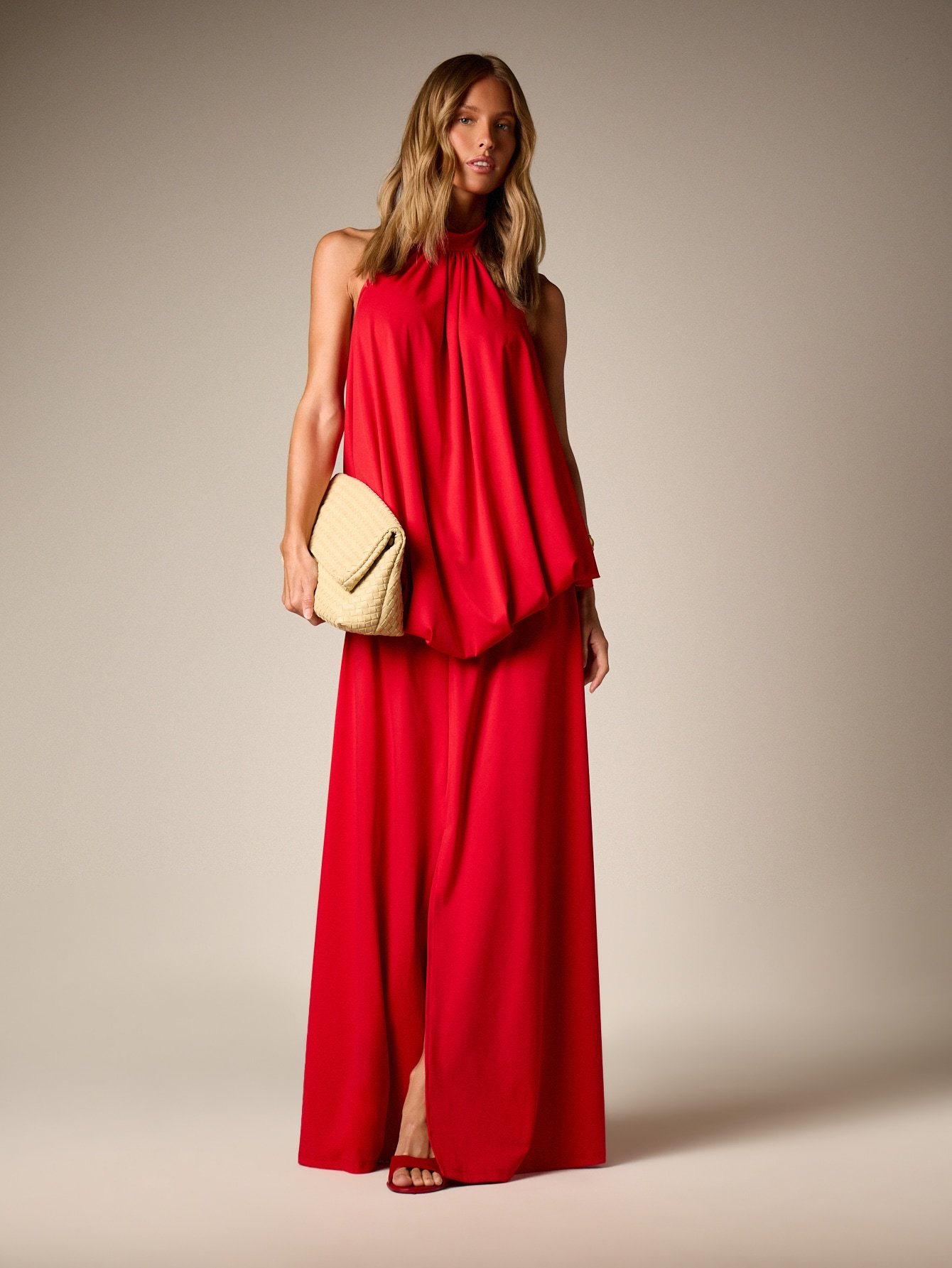 Flowing halter neck evening dress with back bow