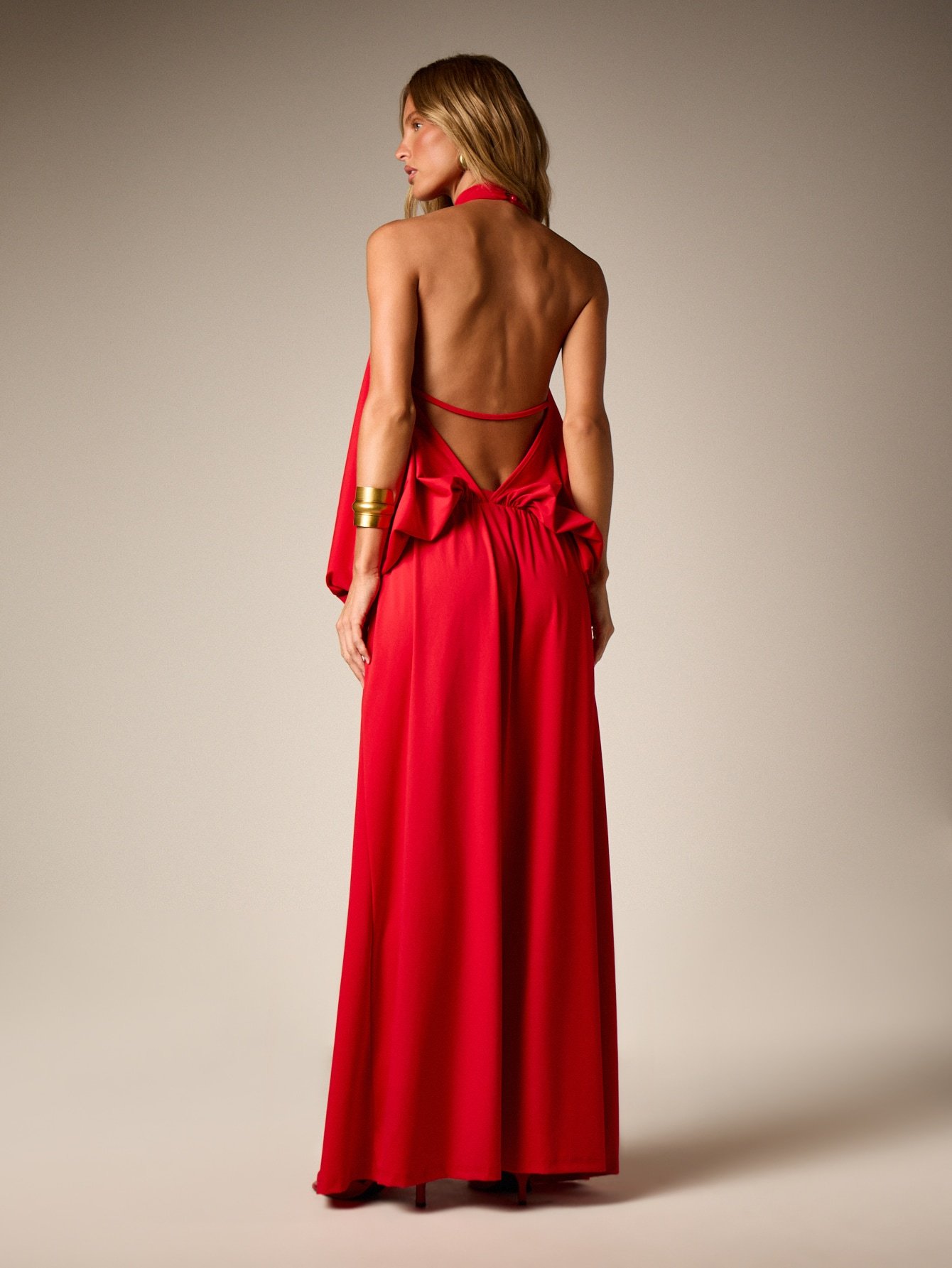 Flowing halter neck evening dress with back bow