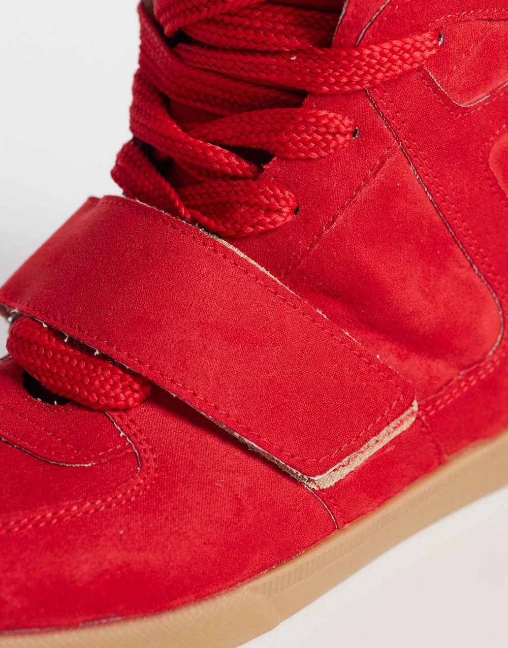 Hidden wedge faux suede trainers in red