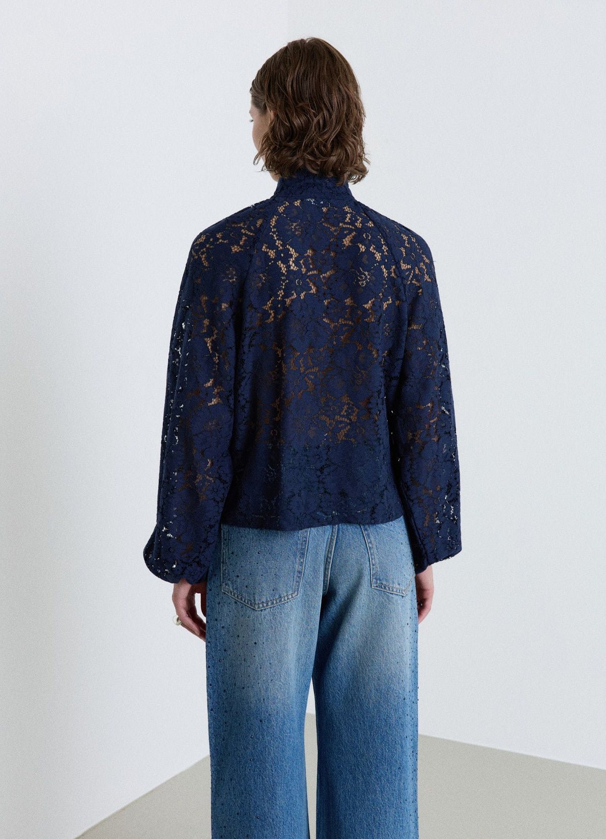 Lace blouse with tied high neck