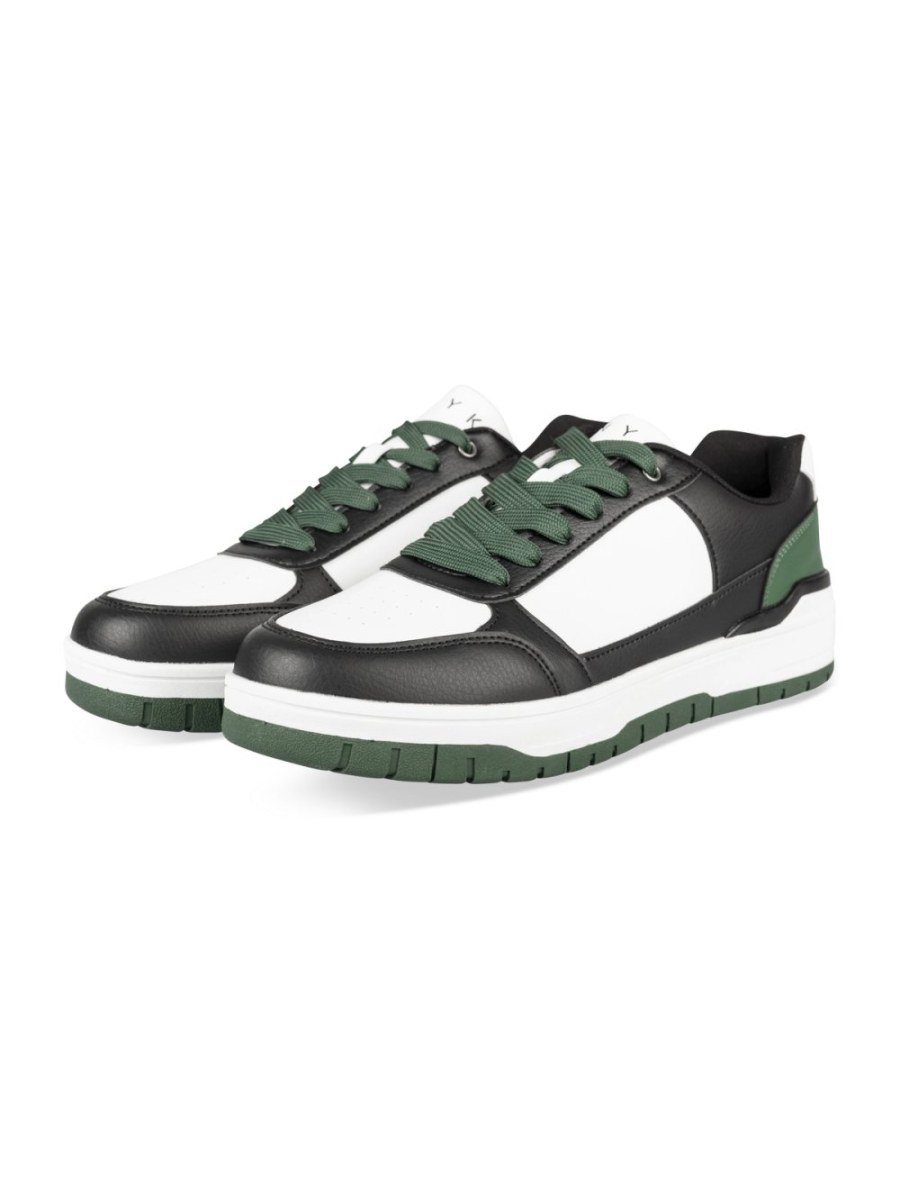 White and black retro sneakers with green sole
