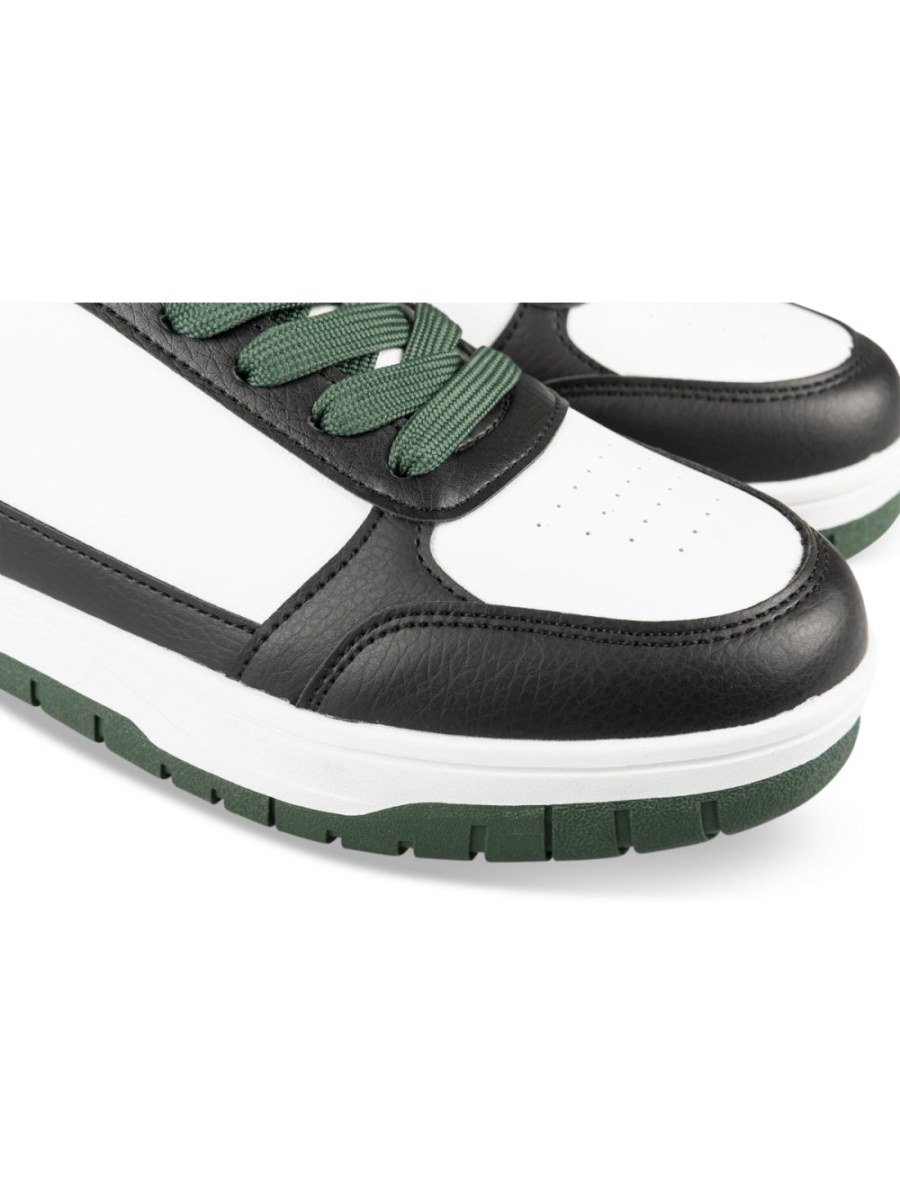 White and black retro sneakers with green sole