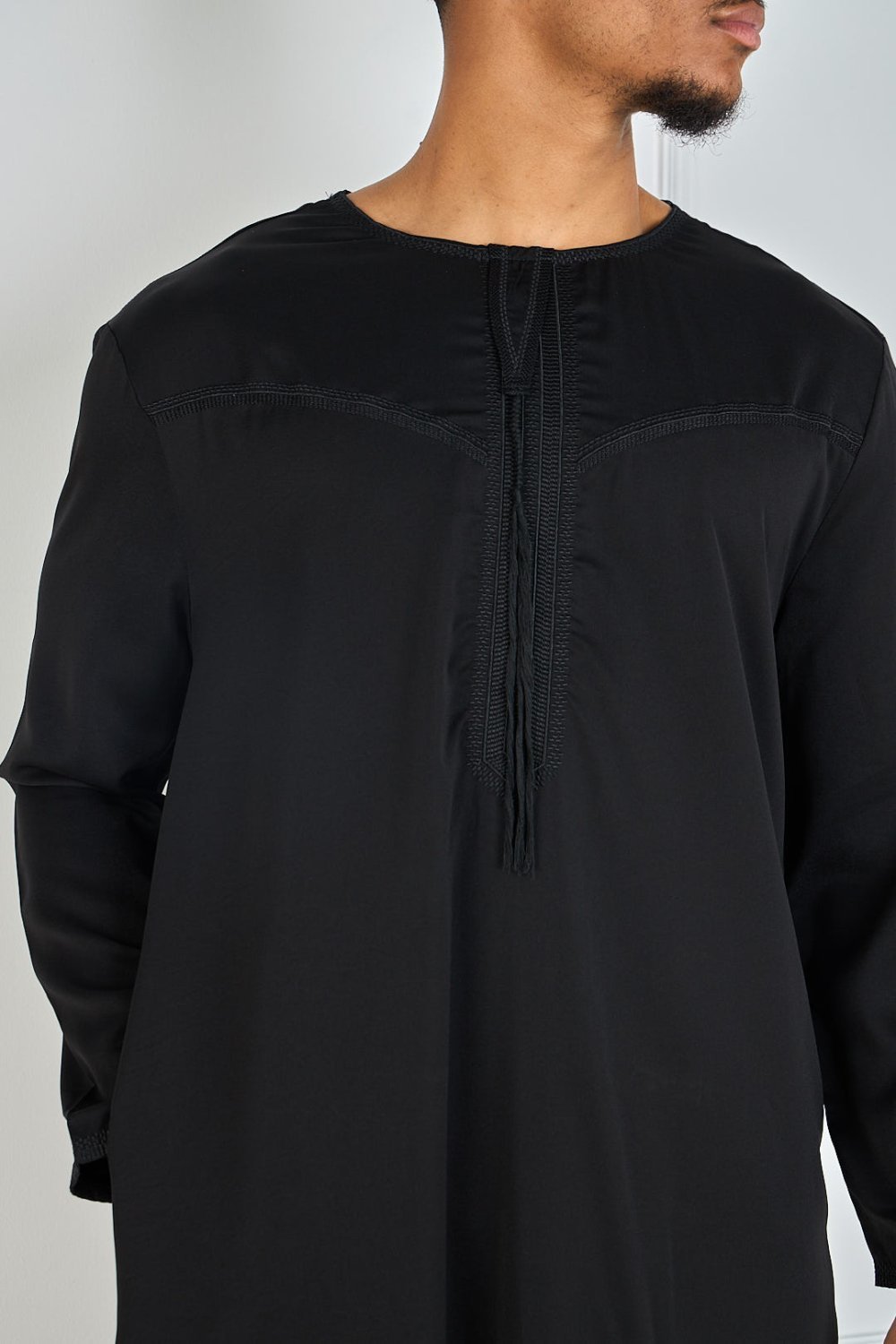 Black qamis with embroidered collar and tassel