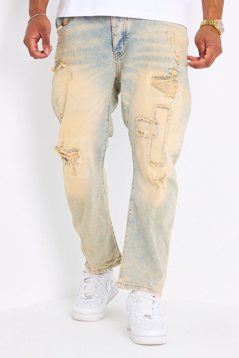 Light blue straight jeans with yellow wash and rips