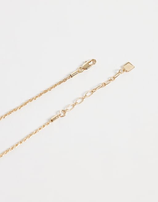 Collier chaîne avec pendentif à détail nœud finition dorée