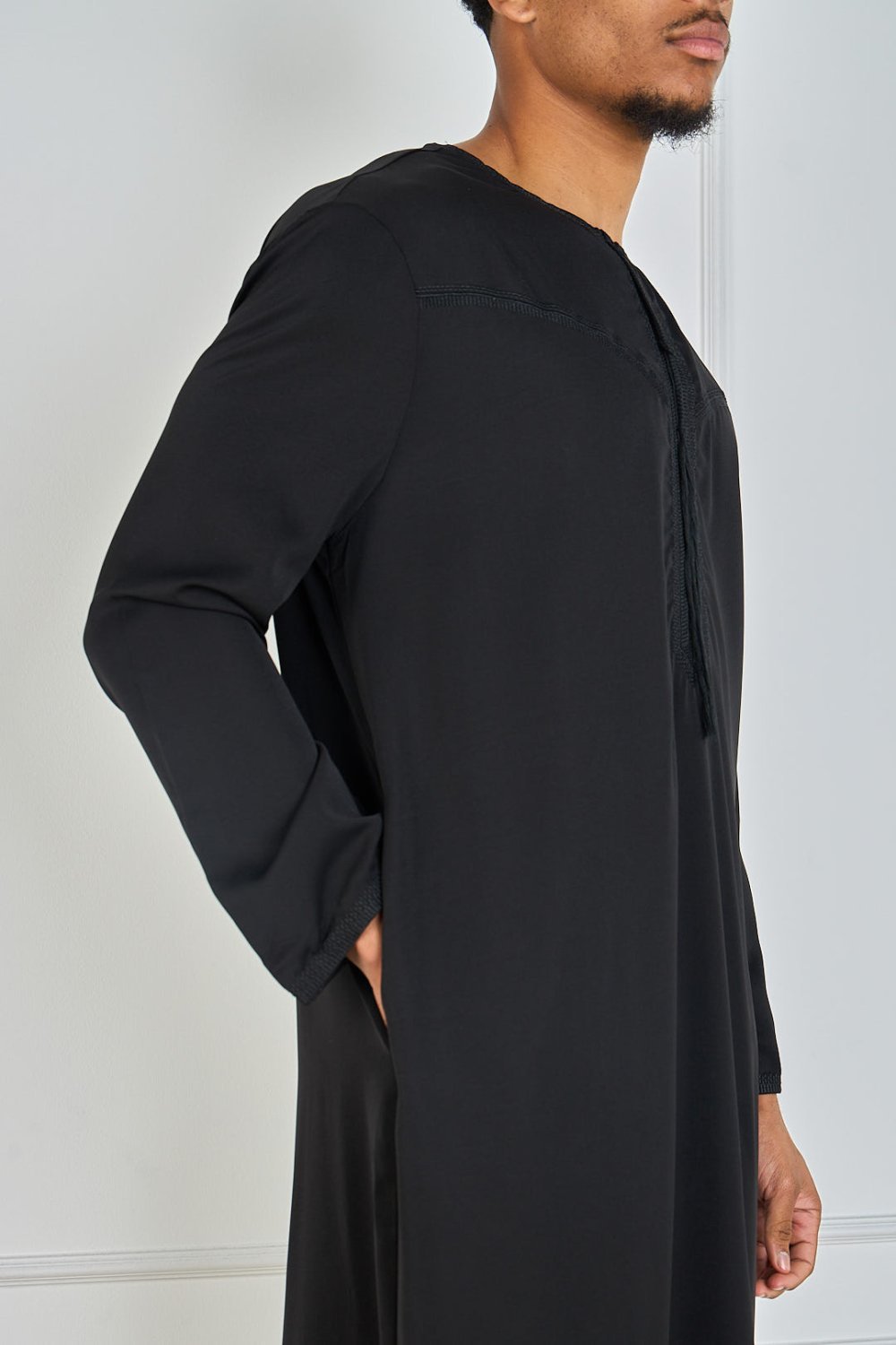 Black qamis with embroidered collar and tassel