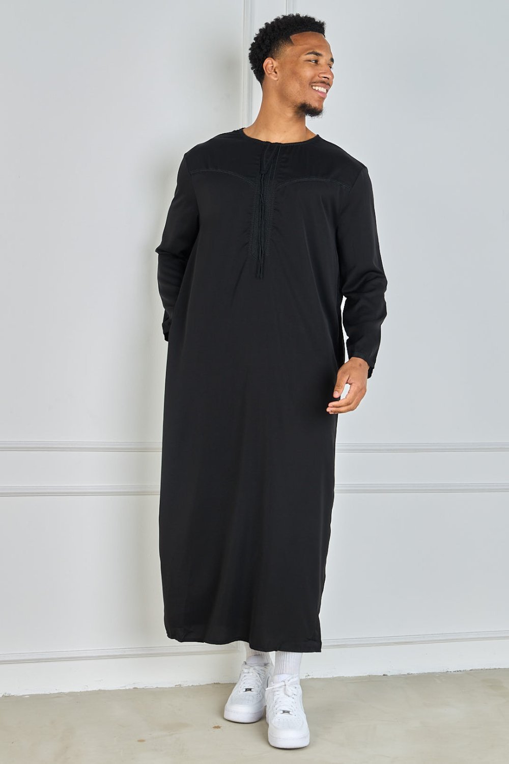 Black qamis with embroidered collar and tassel