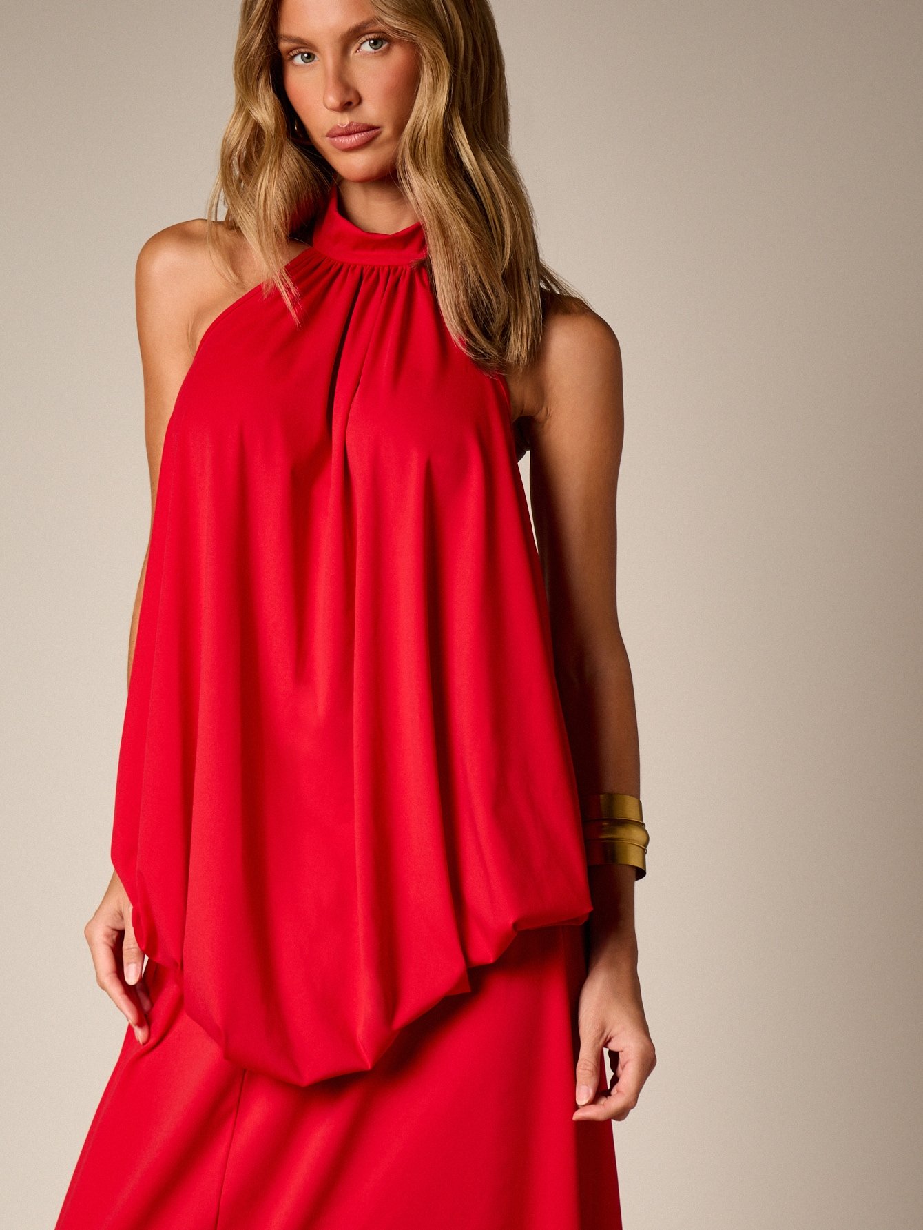 Flowing halter neck evening dress with back bow
