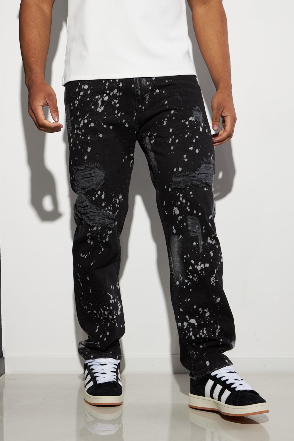 Black ripped jeans with paint splatter